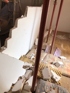 Demolished wall with the help of volunteers Steph and Justin