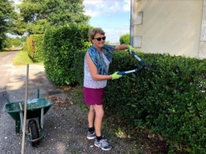 Australian volunteer Ann trimming the hedges outside La Giraudière