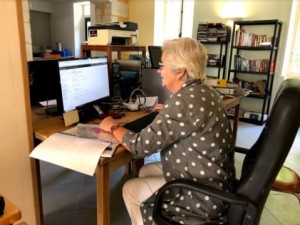 Volunteer in France going through emails at the computer