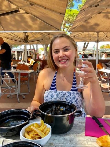 Eilidh enjoying the local delicasey of mussels and chips in Royan