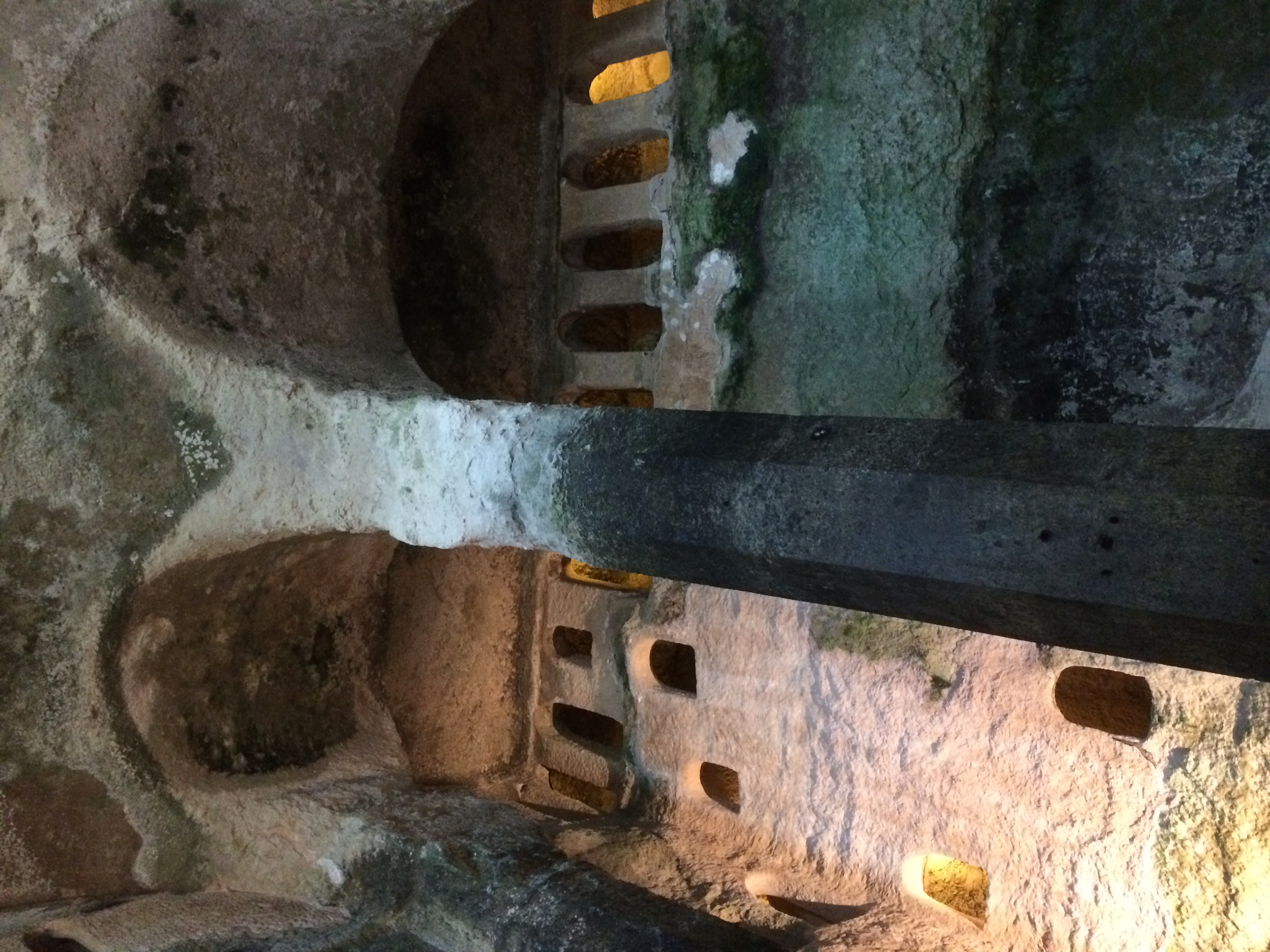 Inside The Church of St Jean, lookiung up at the old, stone pillars